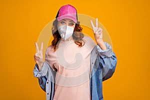 Portrait of her she attractive funky healthy wavy-haired girl wearing safety n95 respirator mask showing double v-sign