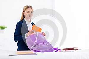 Portrait of her she nice attractive cheerful cheery knowledgeable small little schoolchild packing bag preparing