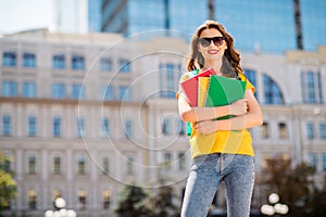 Portrait of her she nice attractive lovely confident cheerful cheery wavy-haired girl hugging holding materials learning