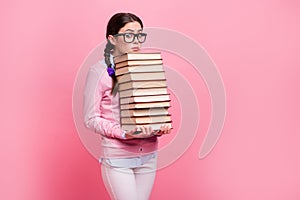 Portrait of her she nice attractive pretty overwhelmed brown-haired teenage girl carrying holding in hands big pile book