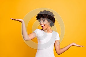 Portrait of her she nice lovely attractive cheerful glad crazy optimistic wavy-haired girl holding two palms copy empty