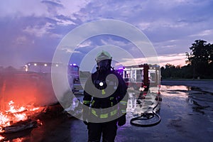 Portrait of a heroic fireman in a protective suit. Firefighter in fire fighting operation.