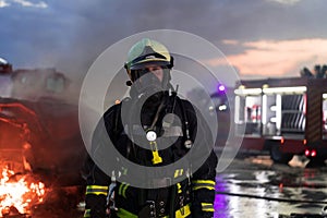 Portrait of a heroic fireman in a protective suit. Firefighter in fire fighting operation.