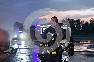 Portrait of a heroic fireman in a protective suit. Firefighter in fire fighting operation.