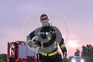 Portrait of a heroic fireman in a protective suit. Firefighter in fire fighting operation.