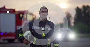 Portrait of a heroic fireman in a protective suit. Firefighter in fire fighting operation.