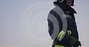 Portrait of a heroic fireman in a protective suit. Firefighter in fire fighting operation.