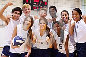 Portrait Of High School Volleyball Team Members With Coach