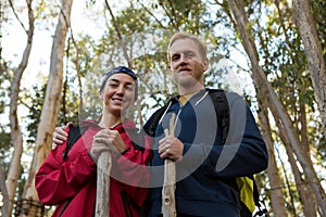 Portrait of hiker couple standing in forest