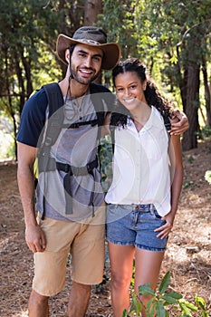 Portrait of hiker couple standing in forest