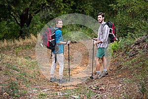 Portrait of hiker couple standing with hiking pole