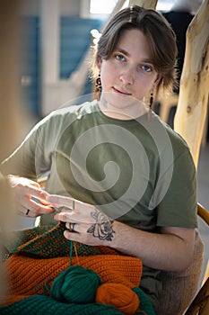 Portrait hipster man enjoy crochet handmade with crocheting supplies art hobby closeup