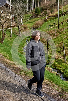 Portrait of a hipster young cute attractive girl traveler travelling in a mountain valley. Happy girl, tourist posing on