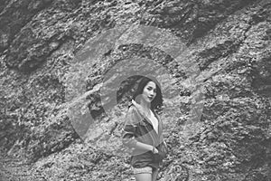 Portrait of hipster young girl standing near cliff and looking camera at outdoor,Happy and smiling,Black and white toned
