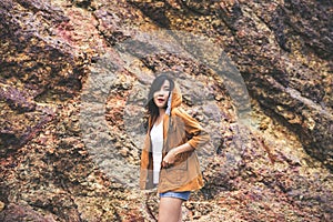 Portrait of hipster young girl standing near cliff and looking something at outdoor,Happy and smiling