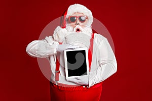 Portrait of his he attractive amazed stunned fat white-haired Santa holding in hands ebook gadget pout lips sale