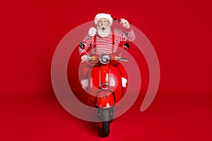 Portrait of his he handsome amazed impressed emotional cheerful bearded Santa riding moped having fun journey fast speed