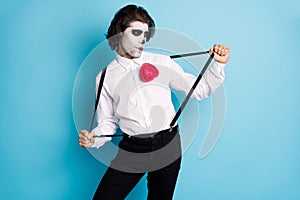 Portrait of his he handsome cool creepy diabolic elegant gentleman guy having fun pulling suspenders dancing theme