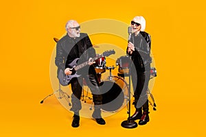 Portrait of his he her she nice attractive cheerful cheery grey-haired couple friends musicians performing singing live