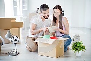 Portrait of his he her she nice attractive lovely cheerful focused couple buyers packing belongings things stuff writing