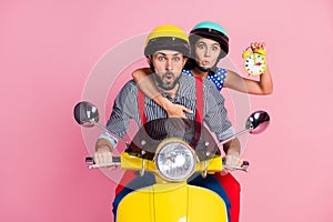 Portrait of his he her she nice attractive worried amazed couple driving moped hurry-up rush holding in hands clock pout