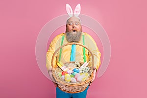 Portrait of his he nice amazed impressed funky glad bearded guy holding in hands giving you festal Easter craft basket