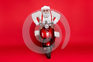 Portrait of his he nice attractive bearded cheerful brutal virile Santa Claus riding bike delivering orders winter