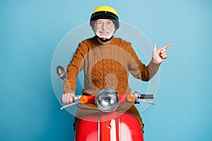 Portrait of his he nice attractive cheerful confident bearded grey-haired man father riding moped showing copy space