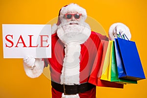 Portrait of his he nice attractive cheerful confident fat Santa holding in hands things buyings board sale advert ad photo