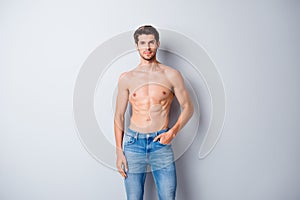 Portrait of his he nice attractive content muscular shirtless guy dandy perfect figure form shape pecs wearing jeans