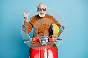 Portrait of his he nice attractive funky cheerful cheery cool naughty bearded grey-haired man hipster sitting on moped