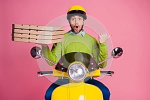 Portrait of his he nice attractive funny amazed guy riding moped carrying pizza pointing aside advert ad new novelty