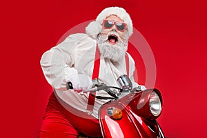 Portrait of his he nice bearded grey-haired cheerful glad funky Santa hipster riding motor bike spending cool December