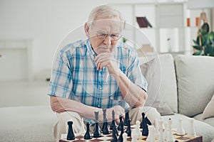 Portrait of his he nice focused concentrated intelligent experienced man playing chess creating move pieces win winner