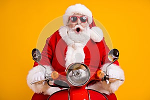 Portrait of his he nice funny amazed stunned cheery Santa riding moped fast speed travel having fun highway winter