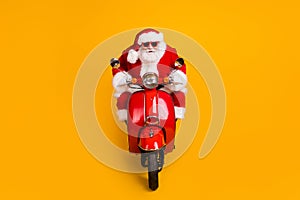 Portrait of his he nice funny fat focused serious Santa St Nicholas driving motor bike traveling highway wintertime