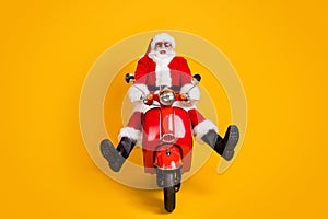 Portrait of his he nice funny playful childish comic hilarious cheerful Santa riding moped having fun fooling fast speed