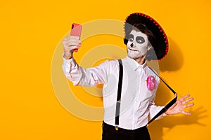 Portrait of his he nice handsome painted spooky guy caballero taking making selfie calavera celebration look outfit photo