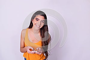 Portrait of hispanic / caucasian young woman using a mobile phon