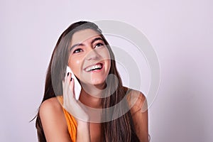 Portrait of hispanic / caucasian young woman using a mobile phon