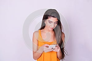 Portrait of hispanic / caucasian young woman using a mobile phon