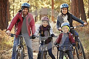 Portrait of Hispanic family on bikes in a forest