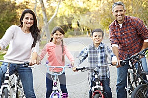 Portrait Of Hispanic Family On Cycle Ride