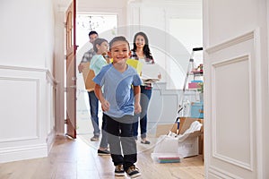Portrait Of Hispanic Family Moving Into New Home