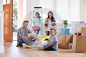 Portrait Of Hispanic Family Moving Into New Home photo