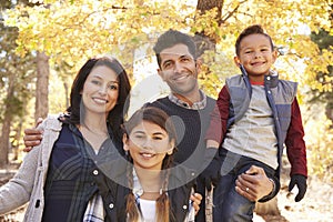 Portrait of Hispanic family outdoors looking at camera