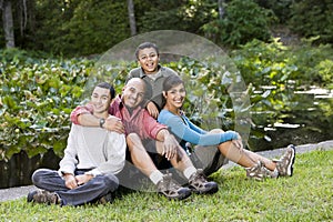 Portrait of Hispanic family with two boys outdoors