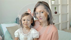 Portrait Hispanic mother and daughter at home, mom and child little girl