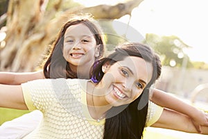 Portrait Of Hispanic Mother And Daughter In Park
