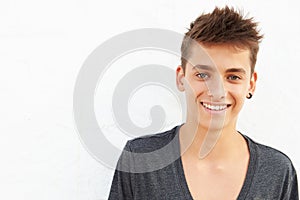 Portrait Of Hispanic Teenage Boy Leaning Against Wall